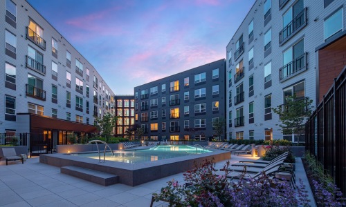 pool with lounge chairs at dusk